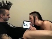 Punk guy with mohawk and bull nose piercing gets a blowjon from his gothic gf